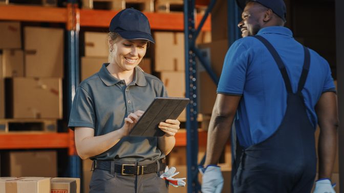 Frontline worker using digital tablet in warehouse