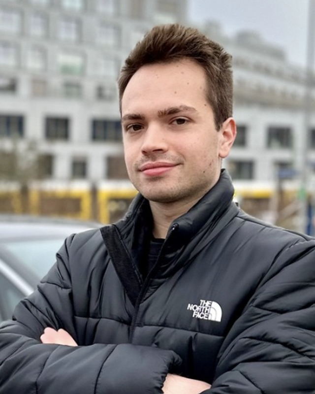 Person in a black North Face jacket standing outdoors.