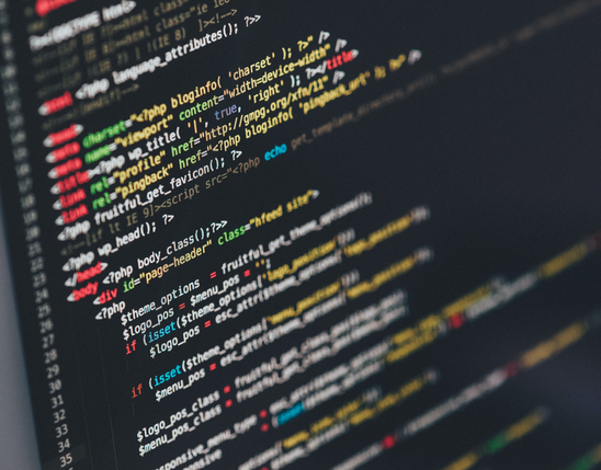 Colorful PHP and HTML code on a dark screen, no B2B-SaaS UI or employee platform visible.