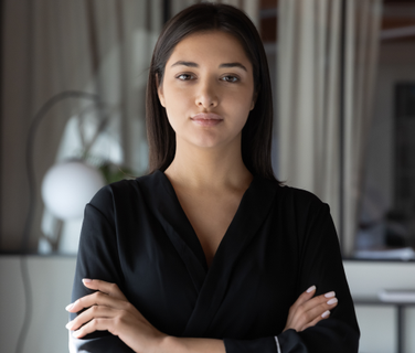 Professional woman in office, arms crossed, no visible UI; image is decorative, no text shown.