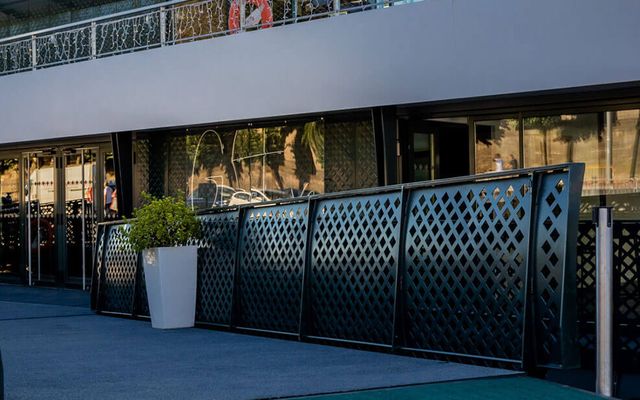 Exterior of a modern event venue with Gustave written on a mat.