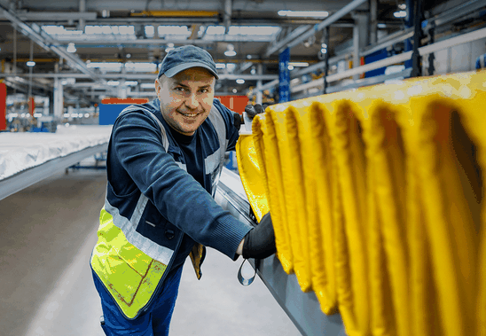Male worker smiling in a manufacturing facility