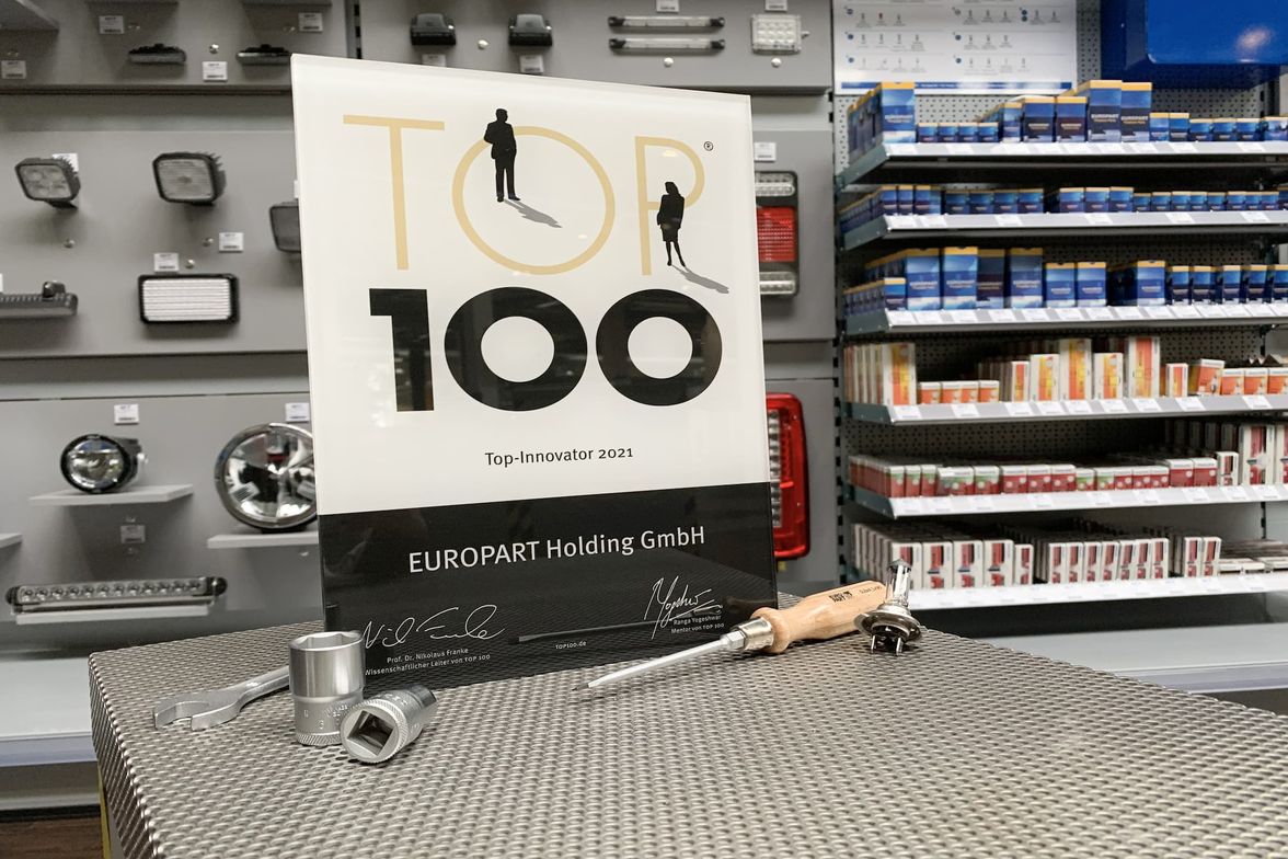 Award plaque and tools on a table in an automotive parts store.