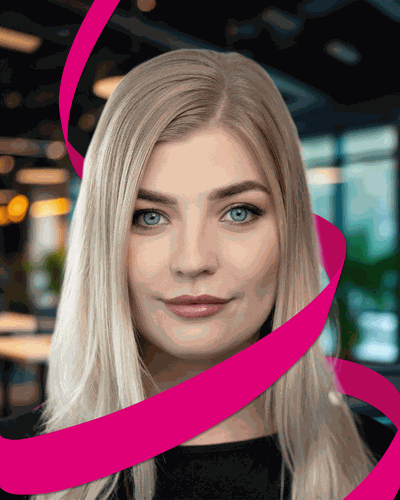 A woman with long blonde hair and blue eyes is wrapped in a pink ribbon, set against a blurred indoor background.