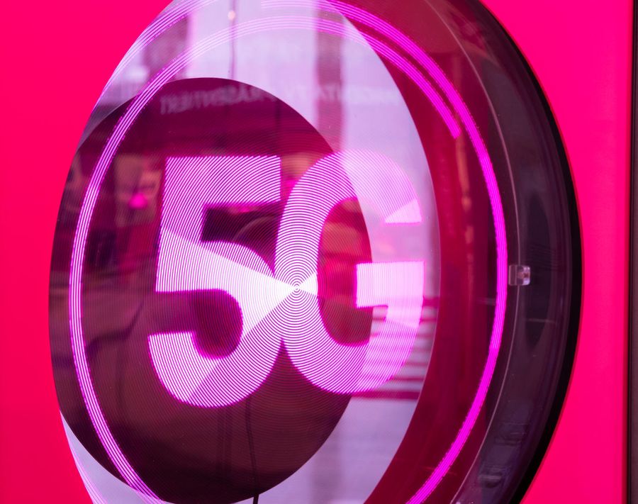 A 3D pink and white 5G logo on a vibrant pink background, symbolizing high-speed wireless technology.