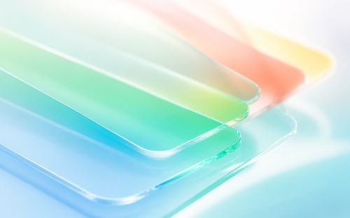 Abstract composition of overlapping transparent sheets in pastel colors, including green, blue, pink, and yellow, with a soft gradient effect.