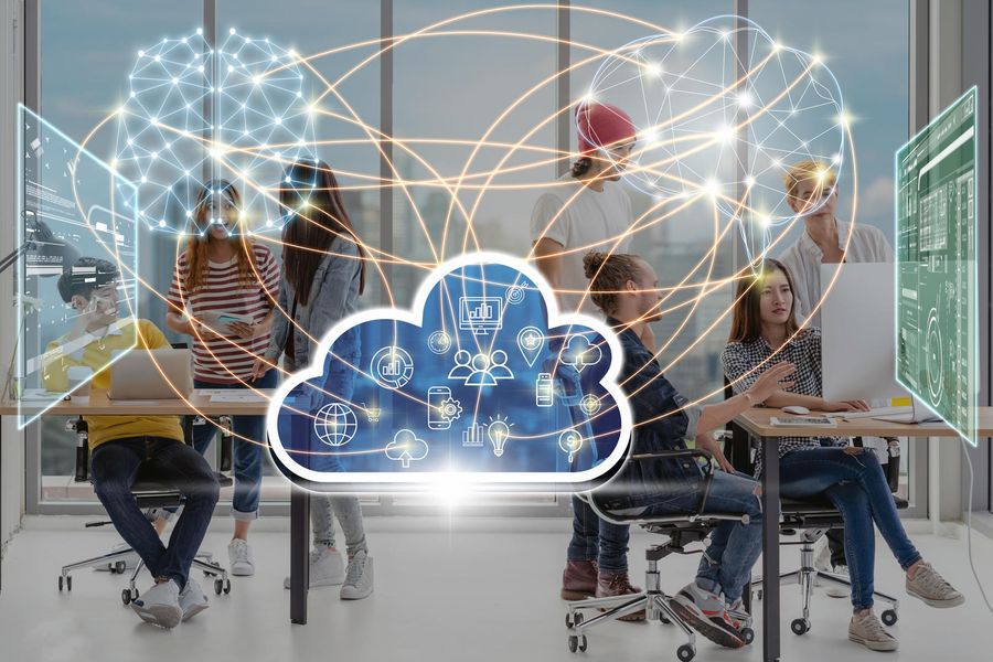 Team collaborating in an office with digital cloud icons and neural connections overlay, symbolizing data sharing and connectivity.