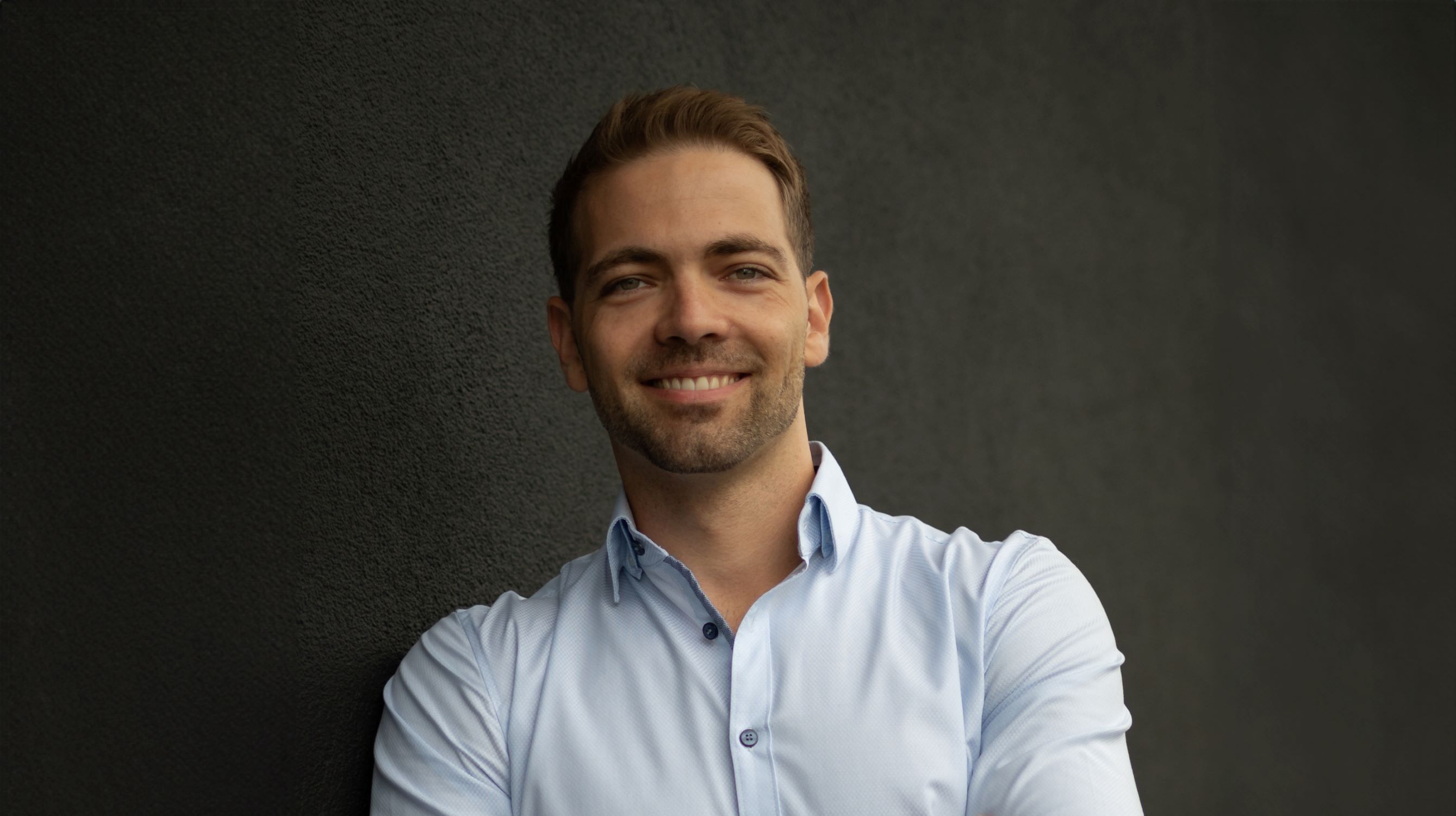 A men smiling into the camera