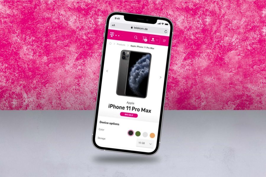 Smartphone displaying a webpage for purchasing an Apple iPhone 11 Pro Max, showing color and storage options, against a pink textured background.