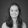 Black and white portrait of Jenny Frøland Steindal, Technical Customer Success Specialist at LINK Mobility. She is part of the Customer Success team and specializes in RCS Business Messaging. Jenny has shoulder-length hair, a slight smile, and is photographed against a plain dark background.