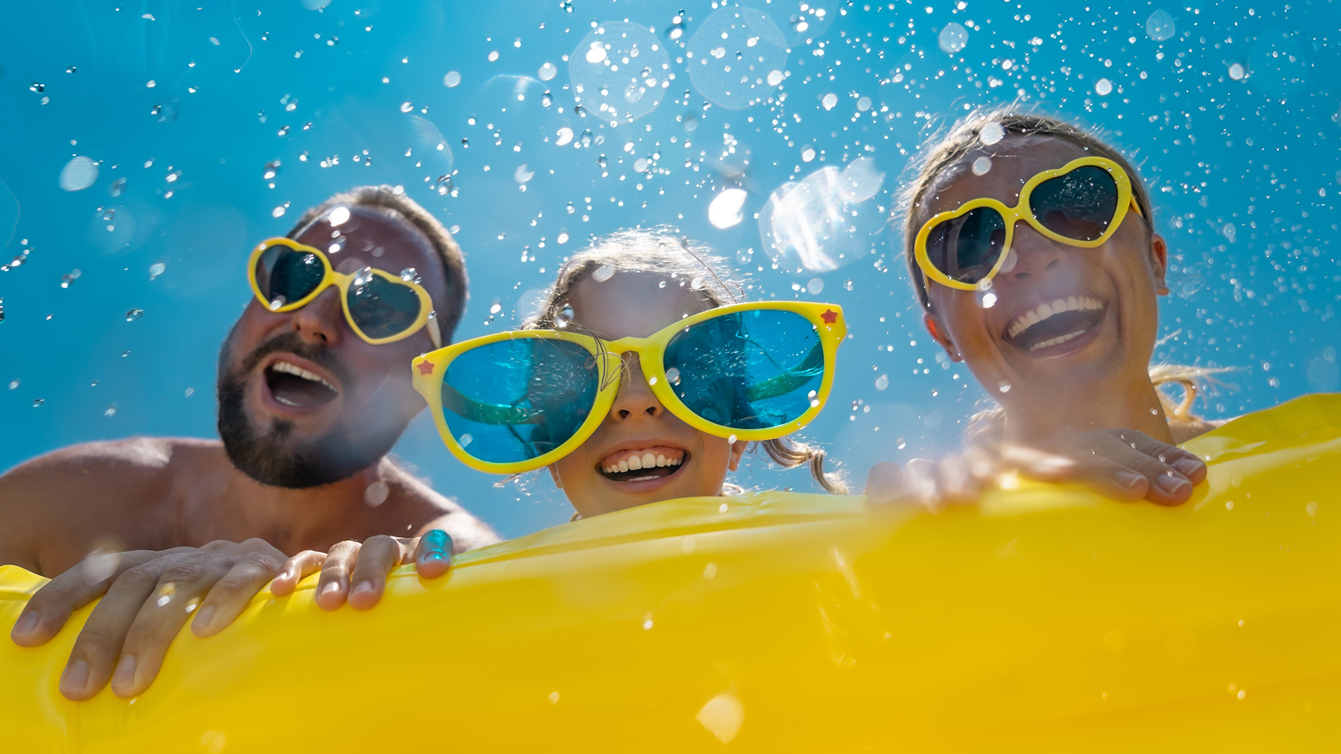 Fröhliche Familie im Sommerurlaub beim Baden.