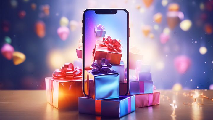 Ein Smartphone, auf dem Geschenkboxen mit bunten Schleifen zu sehen sind, umgeben von schwebenden, verschwommenen Geschenken in festlicher Atmosphäre.