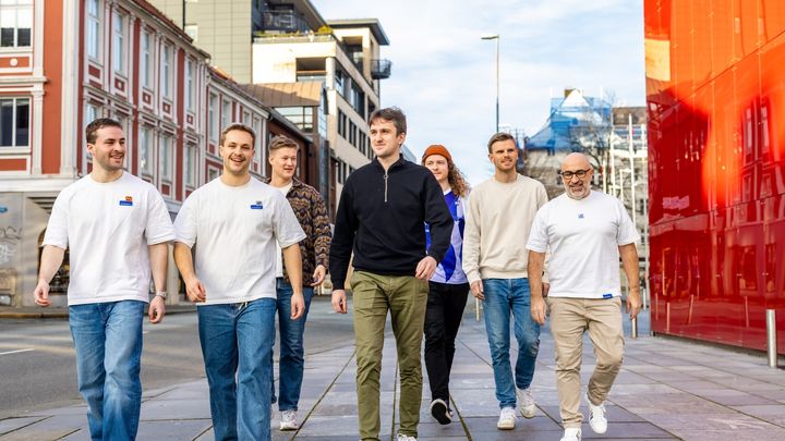 Image of the Heisenbug team walking together outdoors in an urban setting, used in a success story about their successful integration of LINK Mobility’s MyLINK SMS API