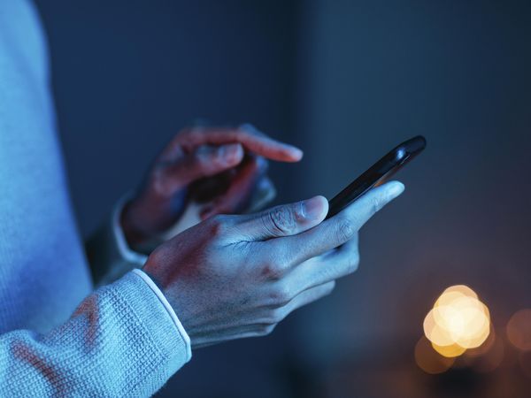 Person interacting with smartphone, illustrating real-time rich messaging, customer engagement, and secure communication enabled by RCS Business Messaging.