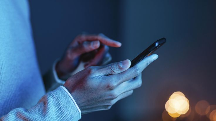 Person interacting with smartphone, illustrating real-time rich messaging, customer engagement, and secure communication enabled by RCS Business Messaging.