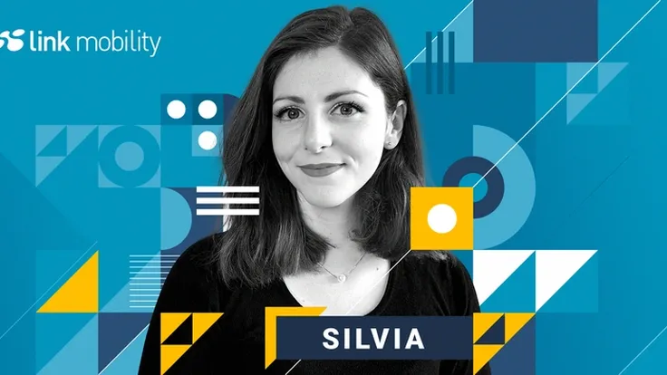 Headshot of Silvia Morresi from LINK Mobility. She has medium-length dark hair, light skin tone, and is smiling softly. The background consists of geometric patterns with circles, squares, rectangles, lines, and triangles in multiple shades of blue, white, and yellow. The LINK Mobility logo is positioned in the top left corner.
