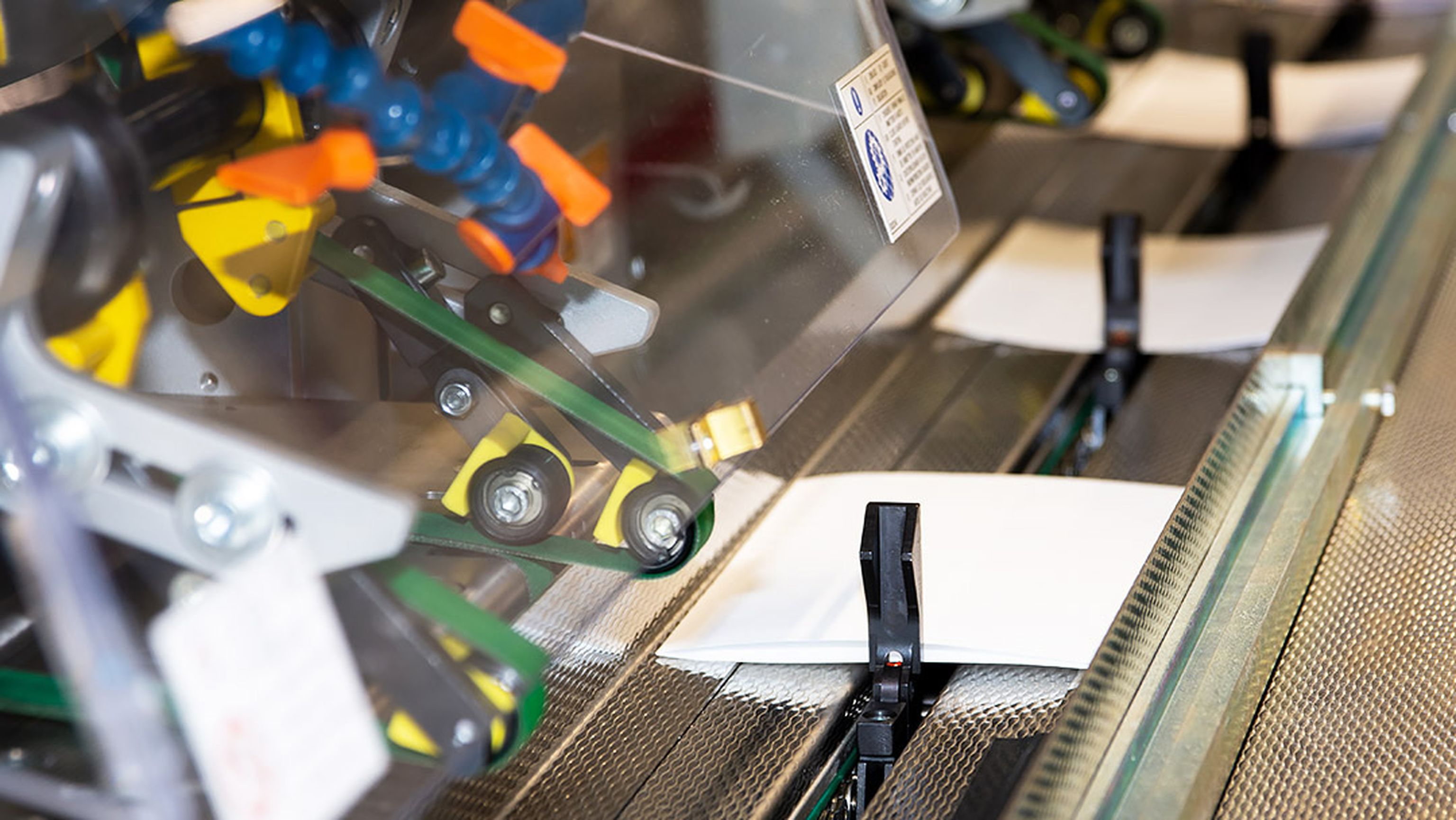 Maskin som sorterar brev på transportband.