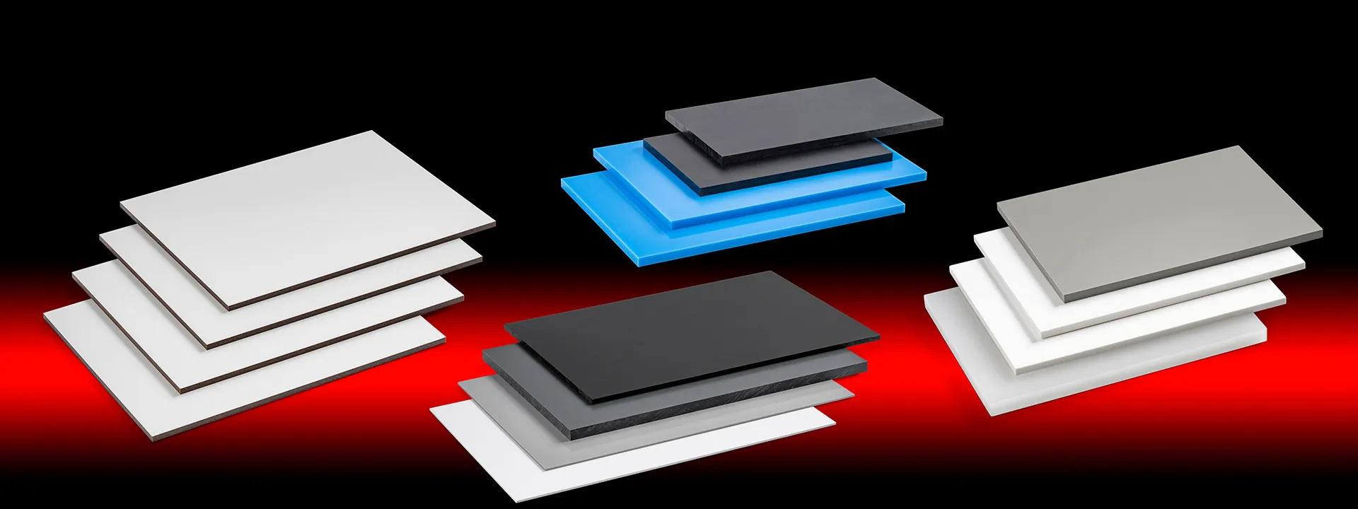 Stacks of flat rectangular panels in white, black, gray, and blue, arranged on a gradient red and black background.