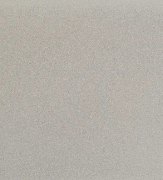 Close-up of a textured beige surface with a subtle grainy pattern, creating a natural and neutral appearance.