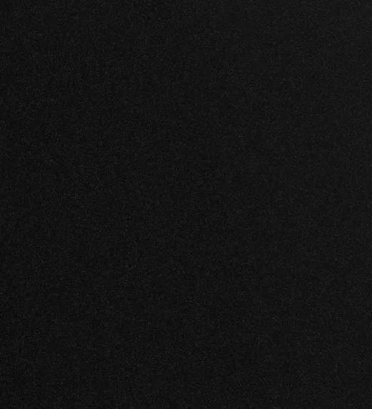 A plain black textured surface with subtle speckles throughout.