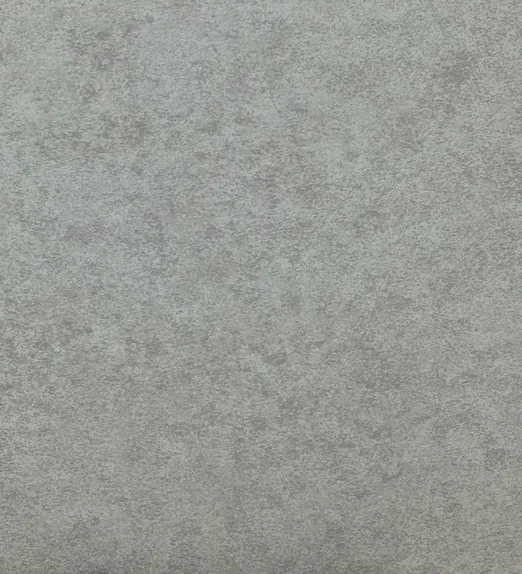 Close-up of a textured gray surface with a mottled pattern, resembling concrete or stone.