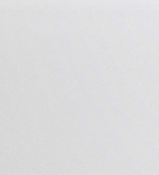 A plain white textured surface with subtle dots and faint diagonal shadows.