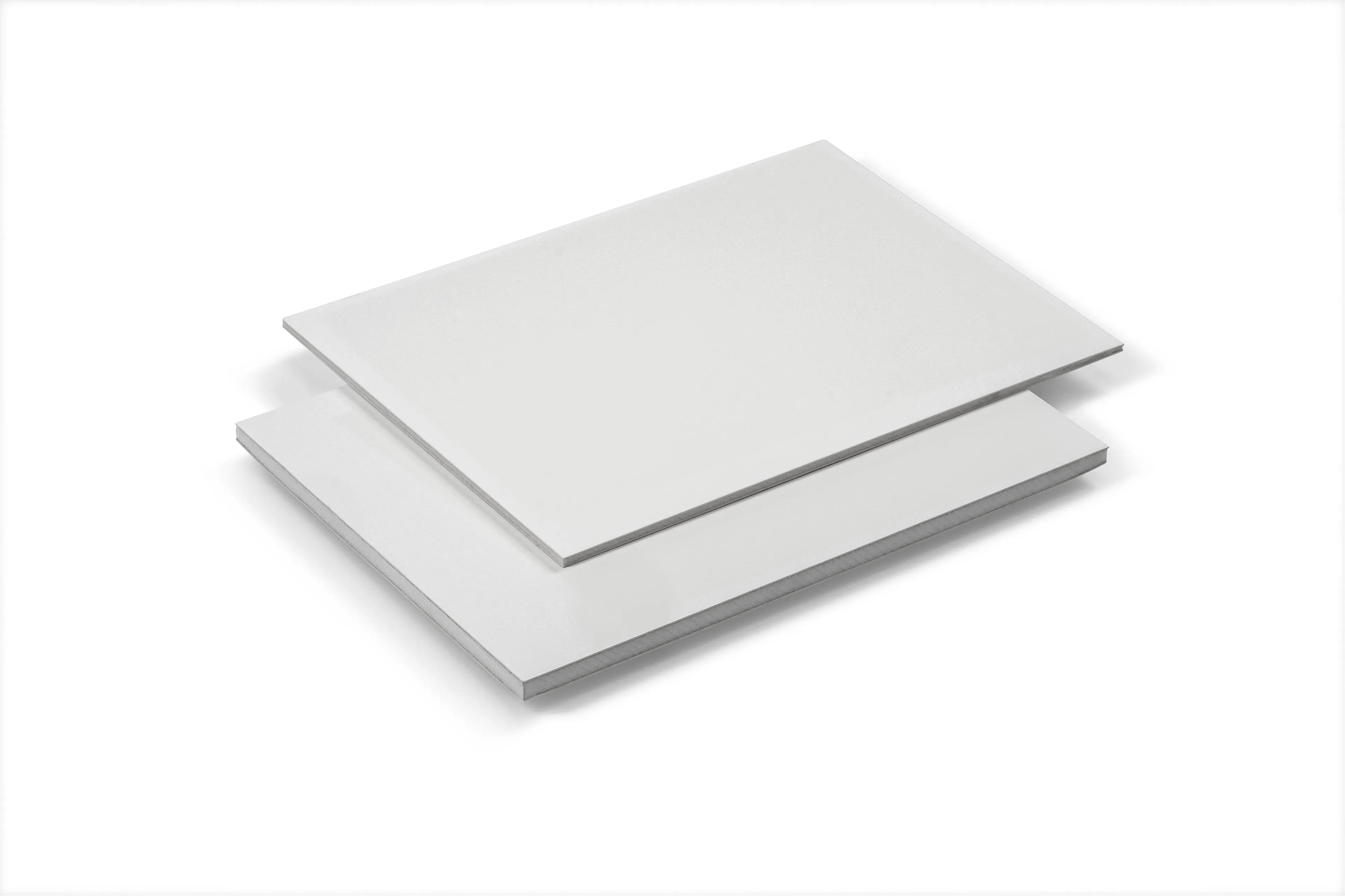 Two stacked blank sheets of white paper on a white background.