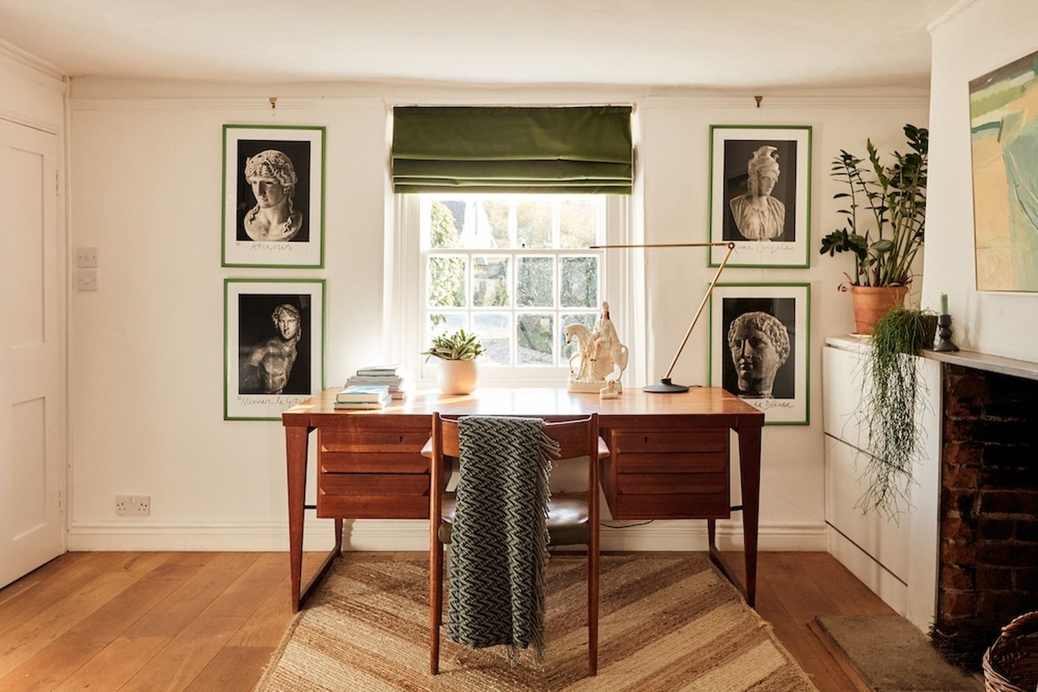 A study room with a desk, chair, and lamp. [G]