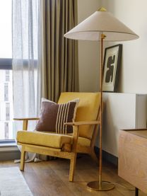 "Stylish reading nook with yellow armchair and brass floor lamp in Way of Life luxury apartment rentals, featuring natural light and modern decor." [G]
