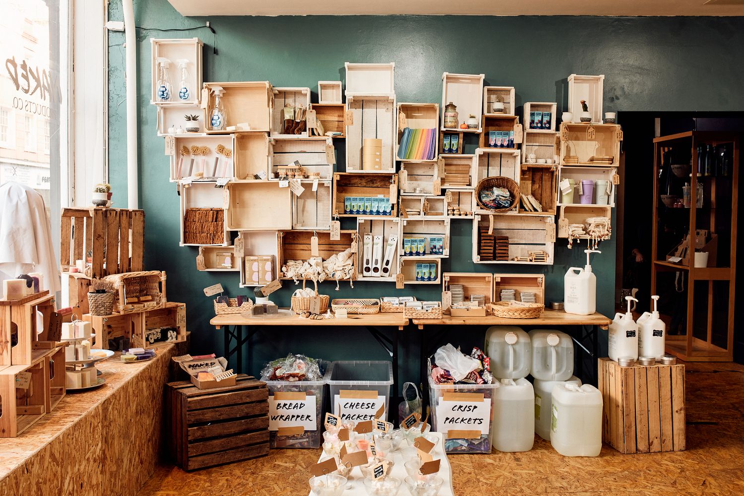 A wooden shelf filled with various items, including bottles, boxes, and baskets. [G]