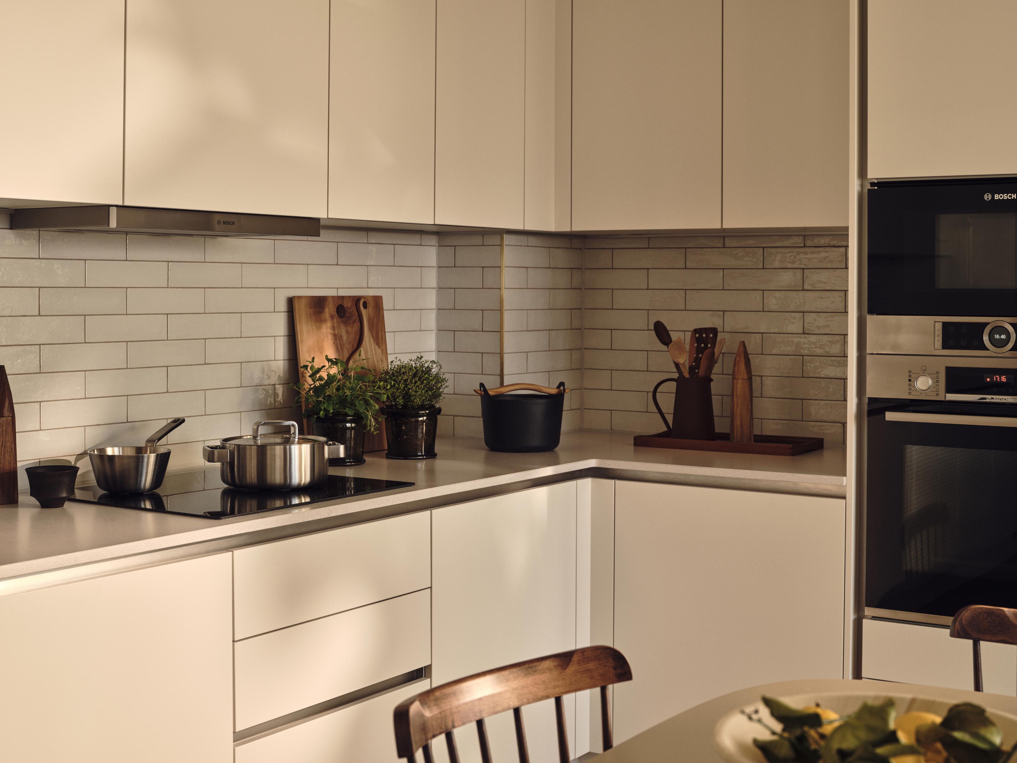 A cozy kitchen scene with white cabinets and a black countertop. A stove with a silver pot and a black pot on the counter. A wooden cutting board with a knife and a wooden bowl. A wooden cutting board with a knife and a wooden bowl. A wooden cutting board with a knife and a wooden bowl. A wooden cutting board with a knife and a wooden bowl. A wooden cutting board with a knife and a wooden bowl. A wooden cutting board with a knife and a wooden bowl. A wooden cutting board with a knife and a wooden bowl. A wooden cutting board with a knife and a wooden bowl. A wooden cutting board with a knife and a wooden bowl. A wooden cutting board with a knife and a wooden bowl. A wooden cutting board with a knife and a wooden bowl. A wooden cutting board with a knife and a wooden bowl. A wooden cutting board with a knife and a wooden bowl. A wooden cutting board with a knife and a wooden bowl. A wooden cutting board with a knife and a wooden bowl. A wooden cutting board with a knife and a wooden bowl. A wooden cutting board with a knife and a wooden bowl. A wooden cutting board with a knife and a wooden bowl. A wooden cutting board with a knife and a wooden bowl. A wooden cutting board with a knife and a wooden bowl. A wooden cutting board with a knife and a wooden bowl. A wooden cutting board with a knife and a wooden bowl. A wooden cutting board with a knife and a wooden bowl. A wooden cutting board with a knife and a wooden bowl. A wooden cutting board with a knife and a wooden bowl. A wooden cutting board with a knife and a wooden bowl. A wooden cutting board with a knife and a wooden bowl. A wooden cutting board with a knife and a wooden bowl. A wooden cutting board with a knife and a wooden bowl. A wooden cutting board with a knife and a wooden bowl. A wooden cutting board with a knife and a wooden bowl. A wooden cutting board with a knife and a wooden bowl. A wooden cutting board with a knife and a wooden bowl. A wooden cutting board with a knife and a wooden bowl. A wooden cutting board with a knife and a wooden bowl. A wooden cutting board with a knife and a wooden bowl. A wooden cutting board with a knife and a wooden bowl. A wooden cutting board with a knife and a wooden bowl. A wooden cutting board with a knife and a wooden bowl. A wooden cutting board with a knife and a wooden bowl. A wooden cutting board with [G]