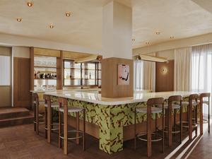 "Elegant bar area with wooden stools and green accents in Way of Life luxury apartment rentals, featuring co-working spaces and natural light." [G]