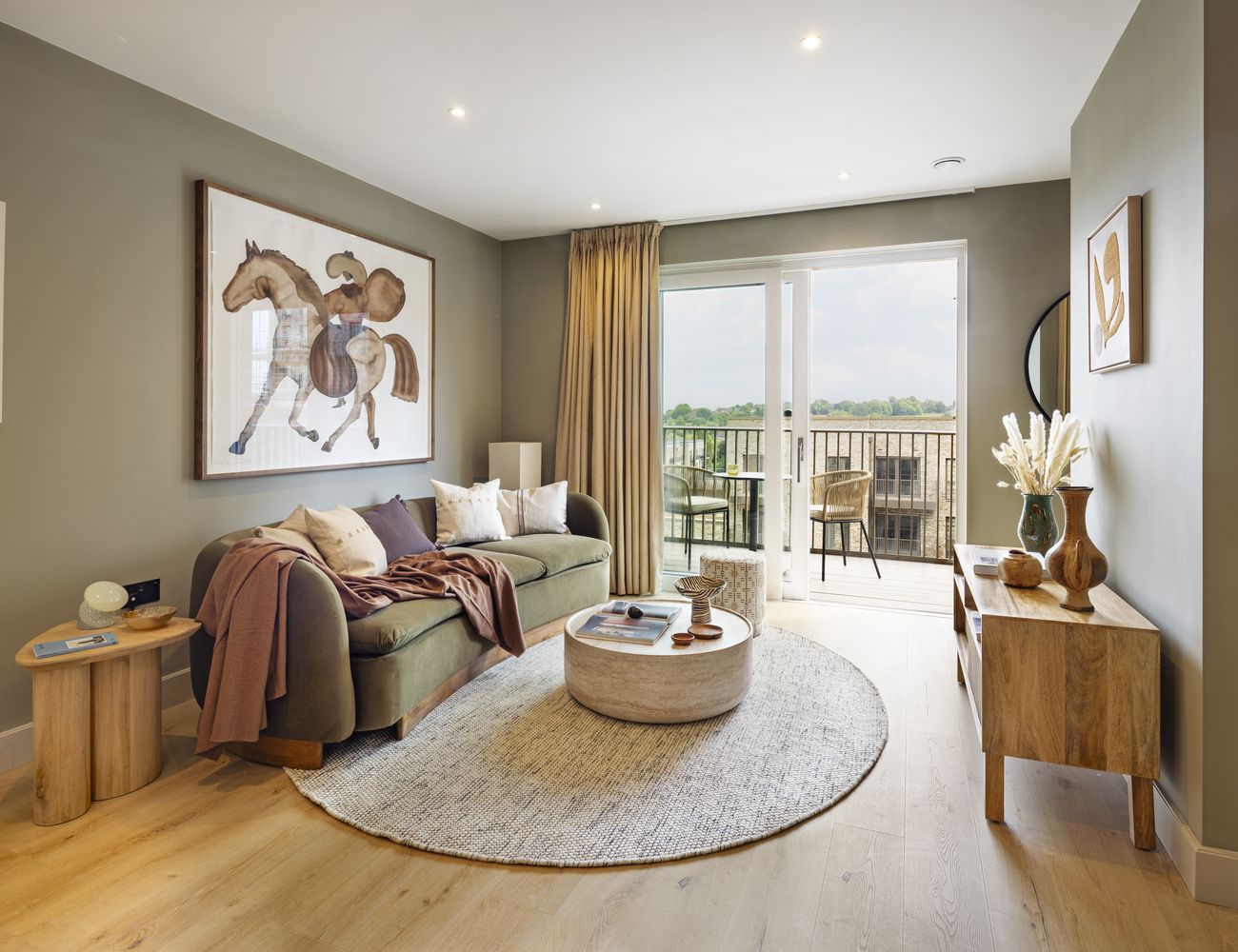 "Elegant living room with balcony view in Way of Life luxury apartment rentals, featuring stylish decor and natural light." [G]