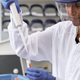 A person in a lab using a pipette