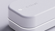 Close-up of a sleek, white rectangular box with rounded edges. Hello Heart logo is embossed on top.