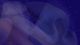 An animation of moving particles against a dark purple background