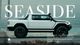 A photo of a white pickup truck with the text Seaside in the background