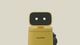Yellow robot with a rectangular black screen and eyes 'blink.' The robot bears the text 'AugustMille.'