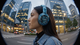 Scenes of different people walking with the same headphones on via a fisheye lens