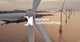 Wind turbines in a serene coastal setting with the Danske Commodities logo overlay, symbolizing the company’s commitment to renewable energy and sustainable practices.