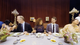 A wide angle view of a group of people at a dinner party