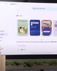A presenter at OpenAI Dev Day 2023 showcases ChatGPT's interface with design options for a "Walk This Way" poster on a large screen.