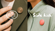 Two images of circular wearable devices, one brown on a green coat and one red on a gray coat. Text reads "RUNE" and "Side kick".