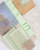 A physical moodboard with different fabrics and materials on a table