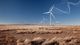 A photo of a desert with an endless amount of windmills