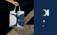 A white tote bag featuring the Danske Commodities logo in a geometric, navy blue design, symbolizing the brand’s presence in casual, everyday contexts.