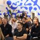 A group of people sitting and facing the front during a workplace event