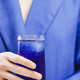 A person holding a blue drink