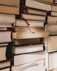 Stacked piles of books, designed into a shape with a light yellow background.