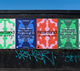 Five colorful concert posters for Heartland, a music event from 18-20 June 2026, featuring Duran Duran and others, on a graffiti-marked wall.